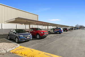 View of parking featuring a carport