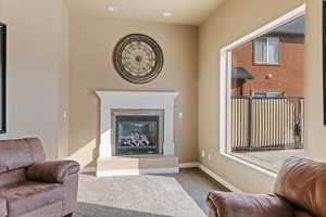 Living room featuring a tile fireplace and carpet floors