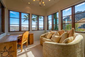 Sunroom / solarium featuring a chandelier, a view of city, and visible vents