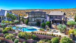 Rear view of house featuring a balcony, a residential view, a fenced in pool, and a patio