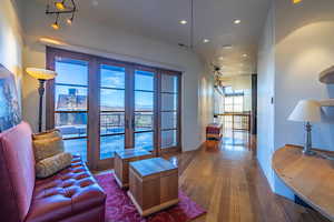 Living area with recessed lighting, wood finished floors, and french doors