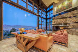 Interior space with stone finish flooring, expansive windows, and a mountain view