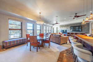 Dining area featuring recessed lighting, a fireplace, and ceiling fan with notable chandelier