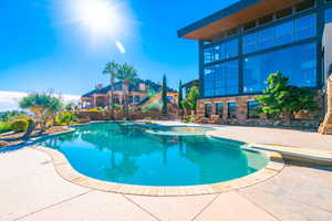 View of pool with a patio area and a fenced in pool