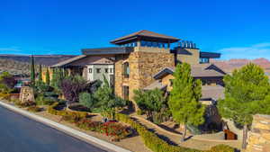 Exterior space featuring stone siding, a mountain view, and stucco siding