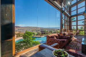 Sunroom / solarium featuring a mountain view