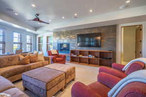 Living room featuring a ceiling fan and recessed lighting