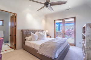 Bedroom featuring french doors, multiple windows, visible vents, and access to exterior