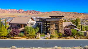 View of front of house with stone siding and a mountain view