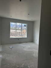 Spare room featuring a textured ceiling and baseboards