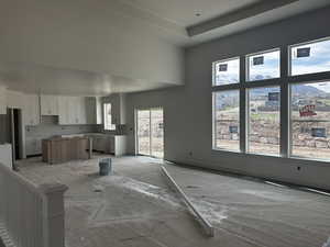 Unfurnished living room with a towering ceiling