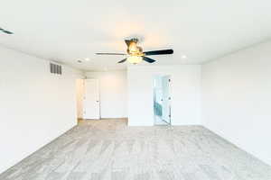 Spare room featuring light carpet, baseboards, visible vents, and recessed lighting