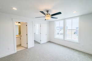 Unfurnished bedroom featuring baseboards, a spacious closet, recessed lighting, and light colored carpet