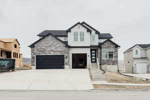 Craftsman house with driveway, a shingled roof, a garage, and board and batten siding