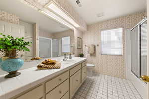 Bathroom with visible vents, baseboards, a shower stall, tile patterned floors, and wallpapered walls