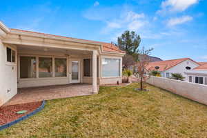 View of yard featuring ceiling fan, a patio, and fence