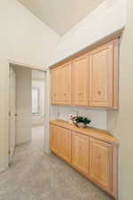 Kitchen with light countertops and light colored carpet