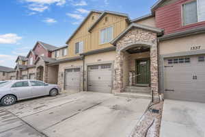 Townhome / 2 car driveway, a garage, stone siding,