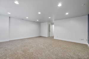 Empty room featuring baseboards, carpet flooring, and recessed lighting, surround sound installed