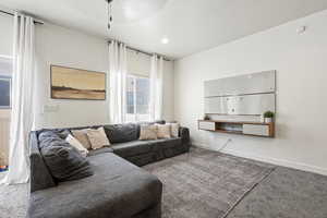 Living room with carpet floors and baseboards