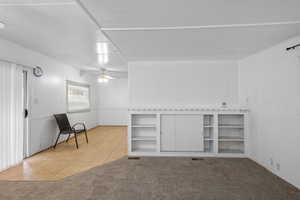 Unfurnished room featuring ceiling fan and carpet floors