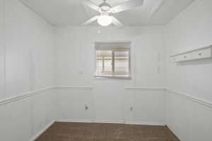 Carpeted empty room featuring ceiling fan