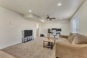 Living area with ceiling fan, recessed lighting, light carpet, and baseboards