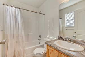 Full bathroom featuring shower / bath combo, vanity, and toilet