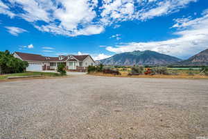 View of front of house featuring a garage, driveway, and a mountain view