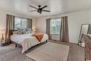 Bedroom featuring multiple windows, baseboards, and a textured ceiling