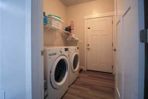 Washroom featuring washer and dryer and dark hardwood / wood-style flooring