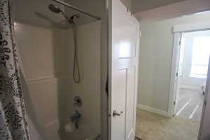 Bathroom featuring shower / bath combo with shower curtain