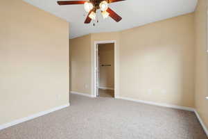 Empty room with carpet flooring and ceiling fan