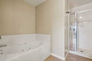 Bathroom with plus walk in shower and tile patterned floors