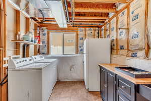 Interior space featuring washing machine and dryer and laundry area