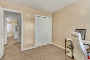 Office space with light colored carpet and baseboards