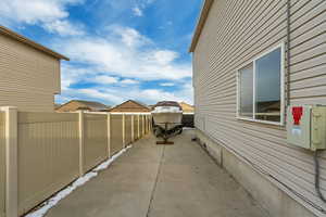 View of home's exterior with a patio and fence