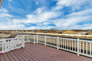 Wooden deck featuring fence and a residential view