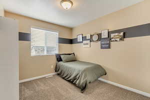 Bedroom with carpet and baseboards