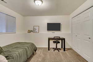 Bedroom featuring light carpet, a closet, visible vents, and baseboards