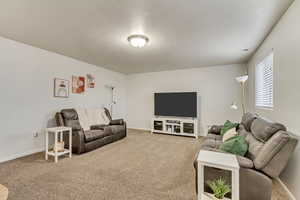 Living room featuring carpet and baseboards