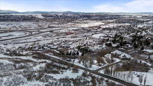 Snowy aerial view featuring a mountain view