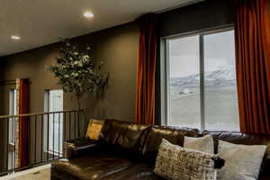 Living area featuring recessed lighting, visible vents, and a mountain view