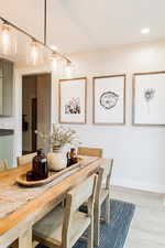 Dining room featuring baseboards, recessed lighting, and light wood-style floors