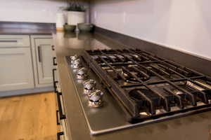 Interior details featuring white cabinetry and stainless steel gas cooktop