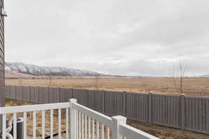 View of yard with a rural view, a mountain view, and central AC unit