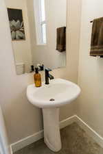 Bathroom with a sink and baseboards