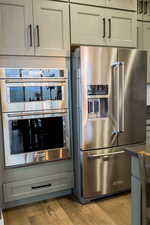 Kitchen featuring light wood finished floors and appliances with stainless steel finishes