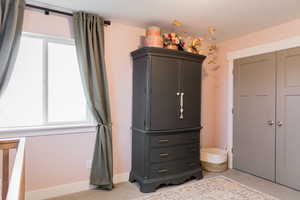 Bedroom with a closet and baseboards