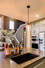 Kitchen with stainless steel appliances, recessed lighting, a sink, and pendant lighting